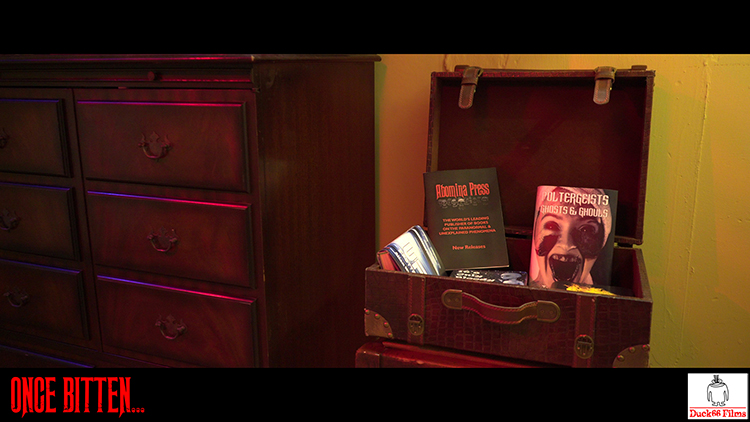 Still frame from Once Bitten… Martha Swales' suitcase of books