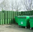Stack of green wheelie bins