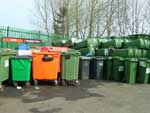 Green and orange wheelie bins