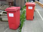 Two red wheelie bins